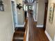 Long hallway boasting gleaming hardwood floors and stylish decor throughout at 324 6Th Ave, Indian Rocks Beach, FL 33785