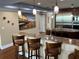 Stylish kitchen with a breakfast bar, marble countertops, stainless steel appliances, and decorative pendant lights at 324 6Th Ave, Indian Rocks Beach, FL 33785