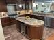 Well-appointed kitchen featuring custom cabinetry, granite countertops, stainless steel appliances, and an island with bar seating at 324 6Th Ave, Indian Rocks Beach, FL 33785