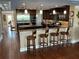 Elegant kitchen with a large island, wooden cabinetry, stainless steel appliances, and pendant lighting at 324 6Th Ave, Indian Rocks Beach, FL 33785