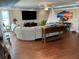 Inviting living room with hardwood floors, a plush sofa, modern décor, and large windows offering ample light at 324 6Th Ave, Indian Rocks Beach, FL 33785