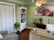 This home office has a modern desk, hardwood floors, and soothing green walls for a productive workspace at 324 6Th Ave, Indian Rocks Beach, FL 33785