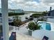 Picturesque view of a backyard oasis with a sparkling pool, boat dock and serene canal views at 324 6Th Ave, Indian Rocks Beach, FL 33785