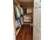 Walk-in closet with rods and shelves for organizing clothes and shoes at 324 6Th Ave, Indian Rocks Beach, FL 33785