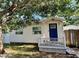 Charming single-story home with white siding, a blue front door, and a cozy porch at 3970 56Th Ave N, St Petersburg, FL 33714