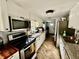 Well-lit kitchen featuring white cabinets, stainless steel appliances, and herringbone floors at 3970 56Th Ave N, St Petersburg, FL 33714