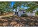Fenced backyard with some greenery and shade from trees at 4017 Moog Rd, Holiday, FL 34691