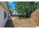 Fenced backyard with patio area and greenery at 4017 Moog Rd, Holiday, FL 34691