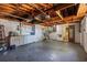 A basement with concrete floors, white walls, washer and dryer, and an unfinished wood ceiling at 4017 Moog Rd, Holiday, FL 34691