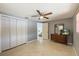 A simple bedroom features a ceiling fan, closet, and natural light from the window at 4017 Moog Rd, Holiday, FL 34691