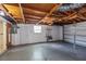 A large garage with concrete floors, white walls, and an unfinished wooden ceiling at 4017 Moog Rd, Holiday, FL 34691