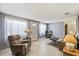 The living room is bright and spacious with neutral paint, comfortable seating, and a coffee table at 4017 Moog Rd, Holiday, FL 34691