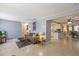 The living room has neutral paint, a comfortable sofa, and a view into the kitchen at 4017 Moog Rd, Holiday, FL 34691