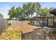 Spacious backyard featuring a screened pool, patio, and ample greenery at 4018 Highgate Dr, Valrico, FL 33594