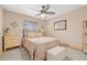 Comfortable bedroom featuring a ceiling fan, neutral decor, and bright natural light at 4018 Highgate Dr, Valrico, FL 33594