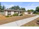 Single-story home with stone accents and a well-maintained lawn on a sunny day at 4018 Highgate Dr, Valrico, FL 33594