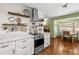 Bright open kitchen and breakfast nook with stainless steel appliances and white cabinets at 4018 Highgate Dr, Valrico, FL 33594