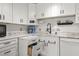 Modern kitchen with white cabinets, granite countertops, stainless appliances and pull out drawer at 4018 Highgate Dr, Valrico, FL 33594
