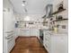 Bright kitchen featuring white cabinets, stainless steel appliances, and hardwood floors at 4018 Highgate Dr, Valrico, FL 33594