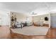 Spacious living room featuring neutral tones, wood floors, a ceiling fan and plenty of natural light at 4018 Highgate Dr, Valrico, FL 33594