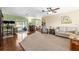 Open living room with wood floors, a cozy atmosphere, and a view of the screened pool area at 4018 Highgate Dr, Valrico, FL 33594