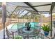 Inviting screened-in pool area featuring outdoor dining and lounging spaces at 4018 Highgate Dr, Valrico, FL 33594