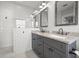 Stylish bathroom featuring a double vanity, walk-in shower and modern finishes at 410 W Chelsea St, Tampa, FL 33603
