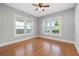 Cozy bedroom with hardwood floors, bright windows, and neutral paint at 410 W Chelsea St, Tampa, FL 33603