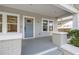 Welcoming front porch with wood-plank flooring, stylish columns, and inviting front entrance at 410 W Chelsea St, Tampa, FL 33603
