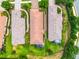 Aerial view showing the roof and backyard with mature trees and the community at 4610 Alexandria Ct, Palmetto, FL 34221