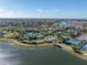 Scenic view of community amenities including a pool, tennis courts, and clubhouse surrounded by a lake at 4610 Alexandria Ct, Palmetto, FL 34221
