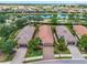 Aerial view of the property showcasing the home's location near a pond and the surrounding community at 4610 Alexandria Ct, Palmetto, FL 34221