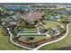 Aerial view of community clubhouse with bowling greens, a fire pit, and beautifully landscaped grounds at 4610 Alexandria Ct, Palmetto, FL 34221