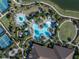 Aerial showcasing resort-style pool with palm trees, adjacent tennis courts, and meticulously manicured landscaping at 4610 Alexandria Ct, Palmetto, FL 34221