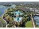Aerial view of a resort-style community pool, amenities, tennis courts, and lush landscaping at 4610 Alexandria Ct, Palmetto, FL 34221