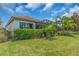The backyard has lush green grass, and mature landscaping providing a private and serene setting at 4610 Alexandria Ct, Palmetto, FL 34221