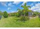 Green backyard featuring a well-manicured lawn, lush landscaping and enclosed patio at 4610 Alexandria Ct, Palmetto, FL 34221