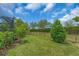 Spacious backyard with manicured lawn, black metal fencing, and mature landscaping at 4610 Alexandria Ct, Palmetto, FL 34221