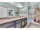 Bathroom with granite counters, dual sinks, updated lighting, and a shower-tub combination at 4610 Alexandria Ct, Palmetto, FL 34221