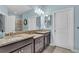 Spacious bathroom featuring double vanity sinks with granite countertops and a large mirror at 4610 Alexandria Ct, Palmetto, FL 34221