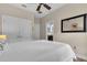 Bright bedroom with a full bed, ceiling fan, mirror, and ensuite bathroom access at 4610 Alexandria Ct, Palmetto, FL 34221