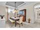 Bright dining room features a stylish chandelier, elegant furnishings, and a hutch cabinet with glass doors at 4610 Alexandria Ct, Palmetto, FL 34221