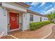 Close-up of front entrance featuring a decorative red door and tiled pathway at 4610 Alexandria Ct, Palmetto, FL 34221
