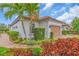View of home's landscaping with vibrant plants and shrubs, and a brick walkway at 4610 Alexandria Ct, Palmetto, FL 34221