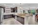 Open kitchen area showcasing granite countertops, dark wood cabinets, and stainless appliances at 4610 Alexandria Ct, Palmetto, FL 34221