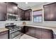 Kitchen with stainless steel oven, granite countertops, and dark wood cabinetry at 4610 Alexandria Ct, Palmetto, FL 34221