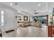 Spacious living room with tiled floors, tray ceiling, large sectional, and access to the patio at 4610 Alexandria Ct, Palmetto, FL 34221