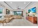 Bright living room featuring a large sectional sofa, tiled floors, and entertainment center at 4610 Alexandria Ct, Palmetto, FL 34221