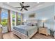 Serene main bedroom with large windows, tray ceiling, and neutral color scheme, offering a relaxing retreat at 4610 Alexandria Ct, Palmetto, FL 34221