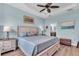 Comfortable main bedroom featuring a ceiling fan, tray ceiling, and light blue walls for a calming atmosphere at 4610 Alexandria Ct, Palmetto, FL 34221
